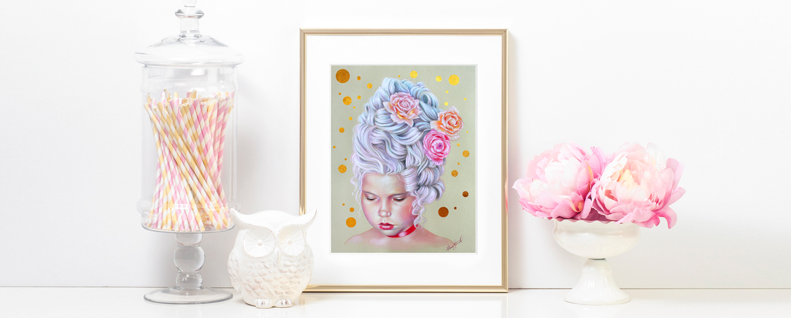 A framed artistic painting by Melanie Stimmell of a woman with flowers in her hair is displayed between a glass container of straws and a vase with pink peonies on a white shelf.
