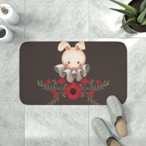 A doormat featuring a whimsical bunny illustration, surrounded by red flowers and green leaves, placed on a tiled floor with a pair of grey slippers nearby.